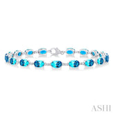 6X4 MM Oval Cut Blue Topaz and 1/6 Ctw Round Cut Diamond Semi-Precious Tennis Bracelet in 10K White Gold