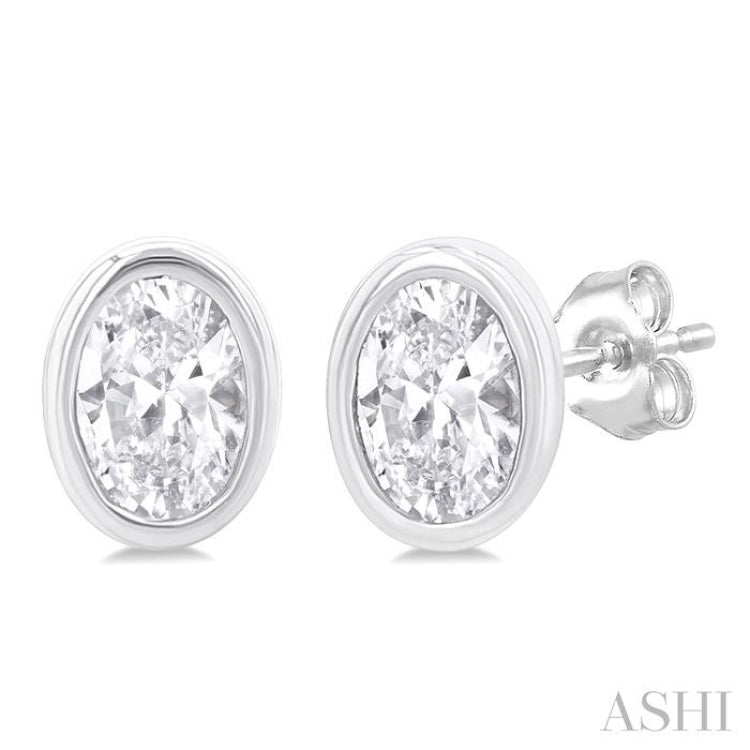 1/5 Ctw Petite Bezel Set Oval Cut Diamond Fashion Stud Earring in 10K White Gold 1/5 Ctw Petite Bezel Set Oval Cut Diamond Fashion Stud Earring in 10K White Gold