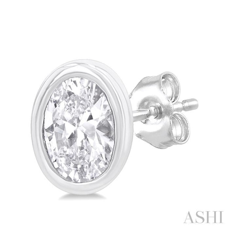 1/5 Ctw Petite Bezel Set Oval Cut Diamond Fashion Stud Earring in 10K White Gold 1/5 Ctw Petite Bezel Set Oval Cut Diamond Fashion Stud Earring in 10K White Gold