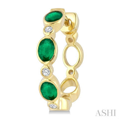 4X3 MM Oval Shape Emerald and 1/20 Ctw Bezel Set Round Cut Diamond Fashion Hoop Earrings in 10K Yellow Gold
